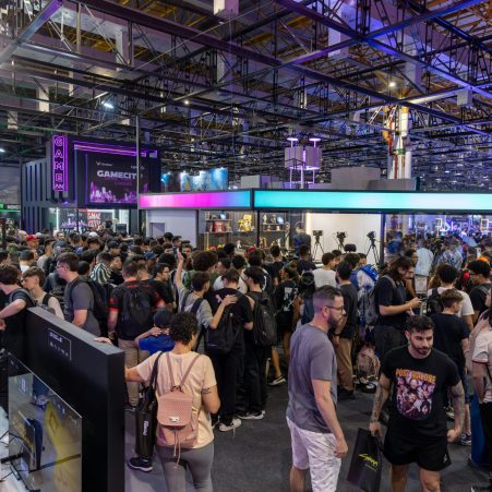 A bustling crowd at a technology convention, showcasing vibrant energy and diverse attendees.